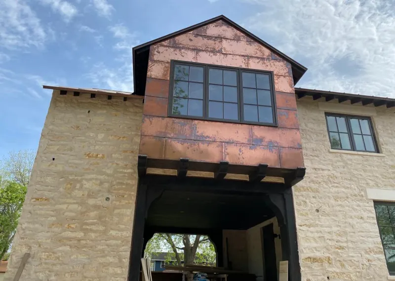 Copper metal panel facade on a stone building for Roof Repair in Richfield