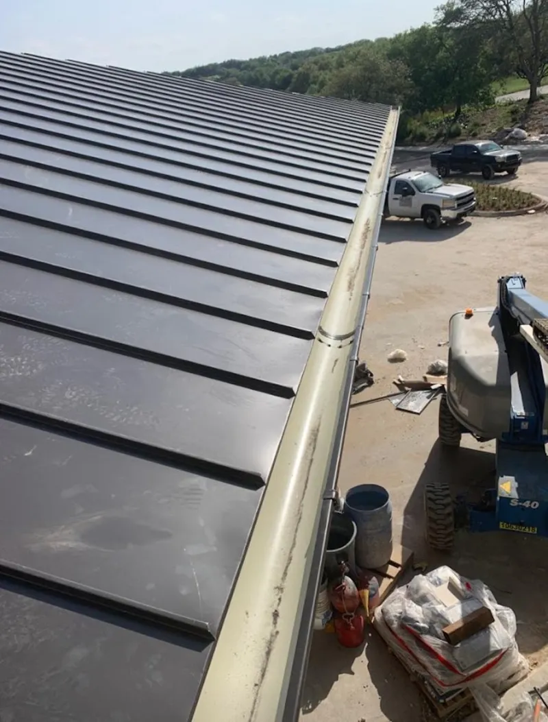 Standing seam panel and gutter detail on a metal roofing jobsite in Richfield